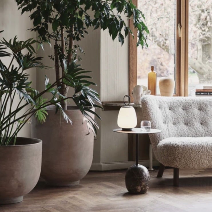 Stone unique side tables styled in a soft, layered living room with plants and warm neutrals, featuring the &Tradition LN8 Lato Oval Side Table with Emperador marble base