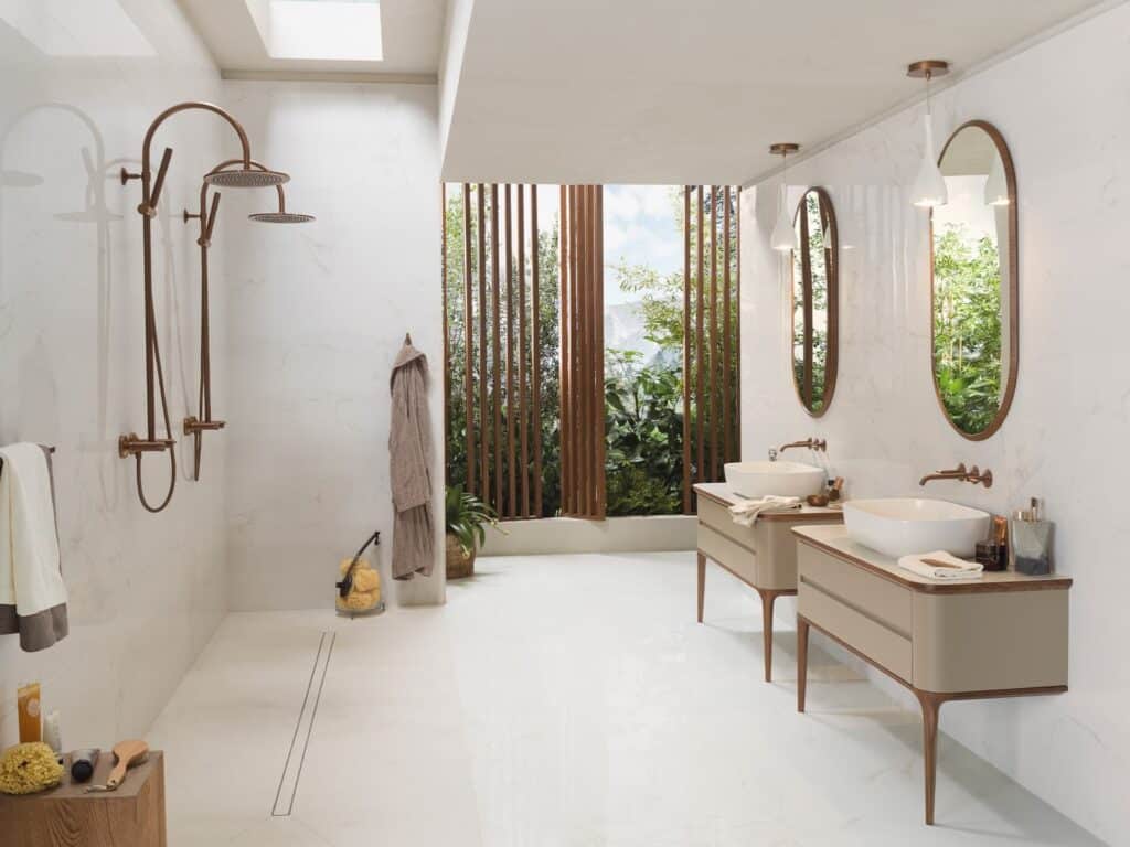 White marble bathroom with copper shower, twin vessel basins, timber vanity and outdoor garden view