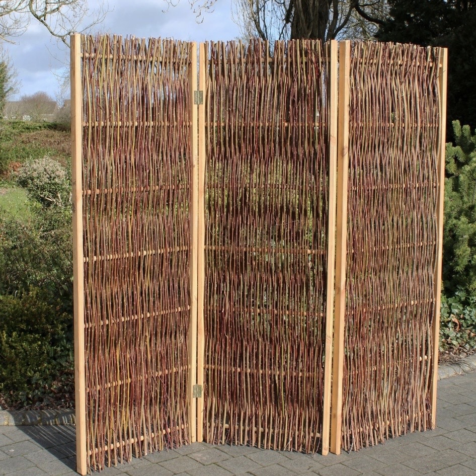 Three-panel woven willow folding screen on wooden frame, freestanding outdoors on patio