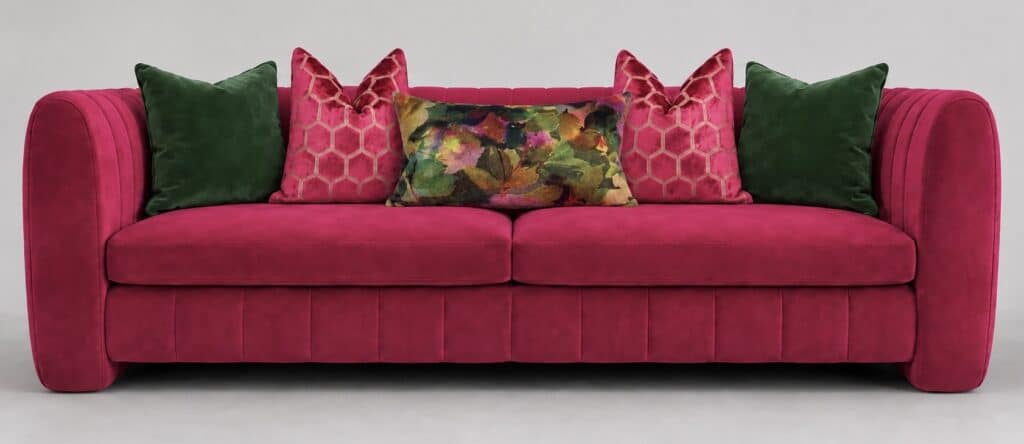 Hot pink velvet sofa layered with forest green, hexagon floral pink and green cushions