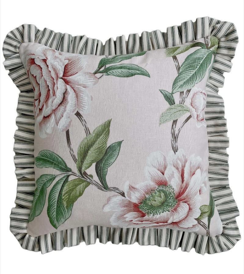 Pink and green cushions with floral print and striped ruffle trim