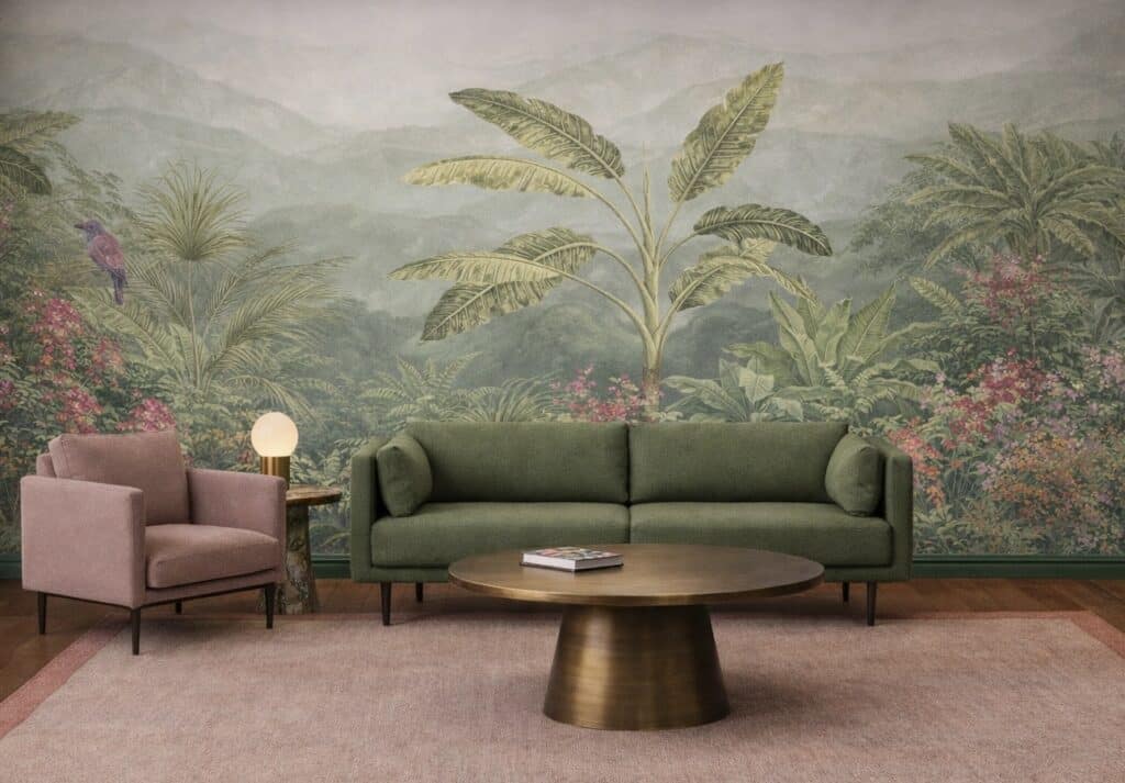 Pink and green living room with tropical wallpaper, green sofa, blush armchair, bronze coffee table and pink rug