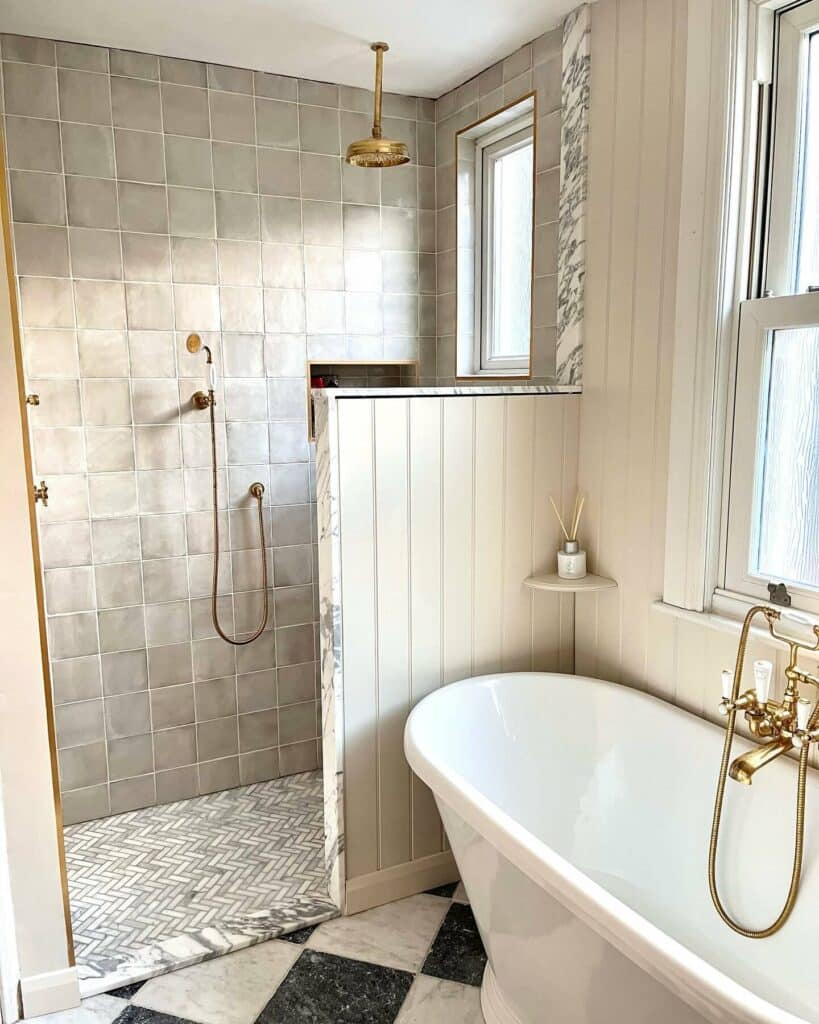 Rustic bathroom with Farrow and Ball Dimity tongue and groove panelling, freestanding bath with brass fittings and walk-in shower with zellige tiles