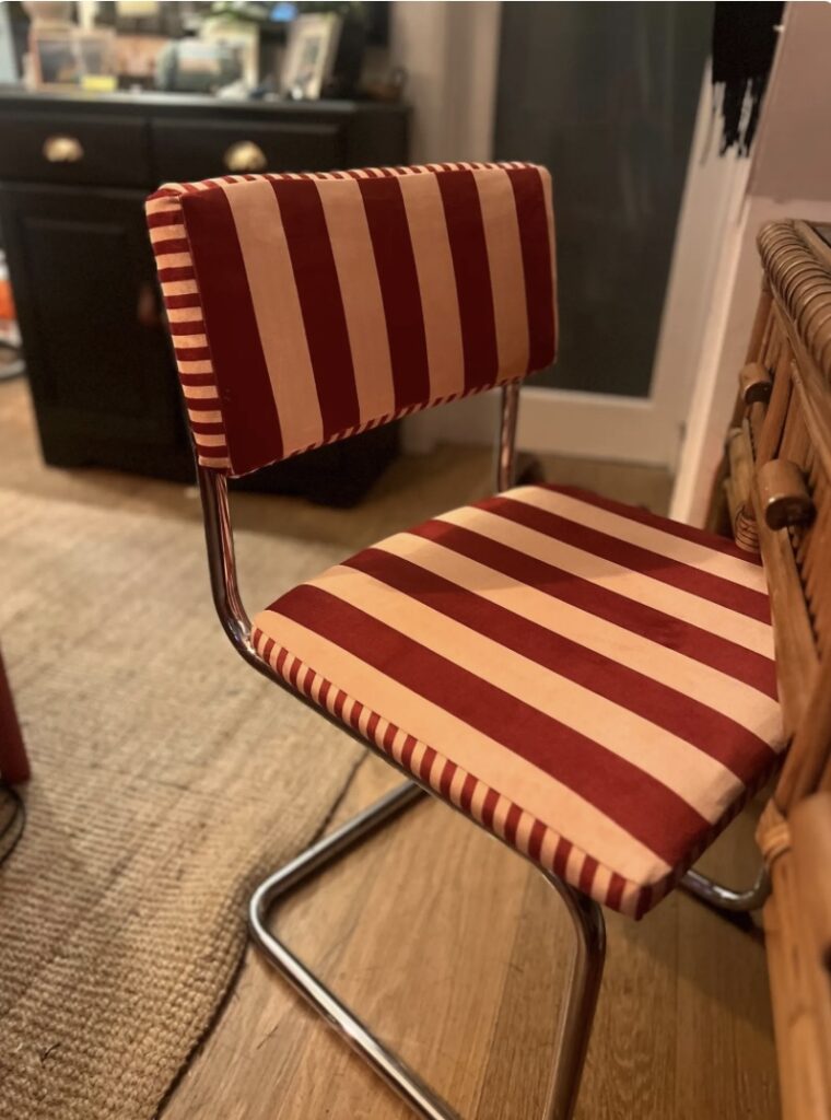 Vintage upcycled Cantilever dining chair with red and cream striped velvet upholstery and chrome frame, styled in a retro-inspired interior