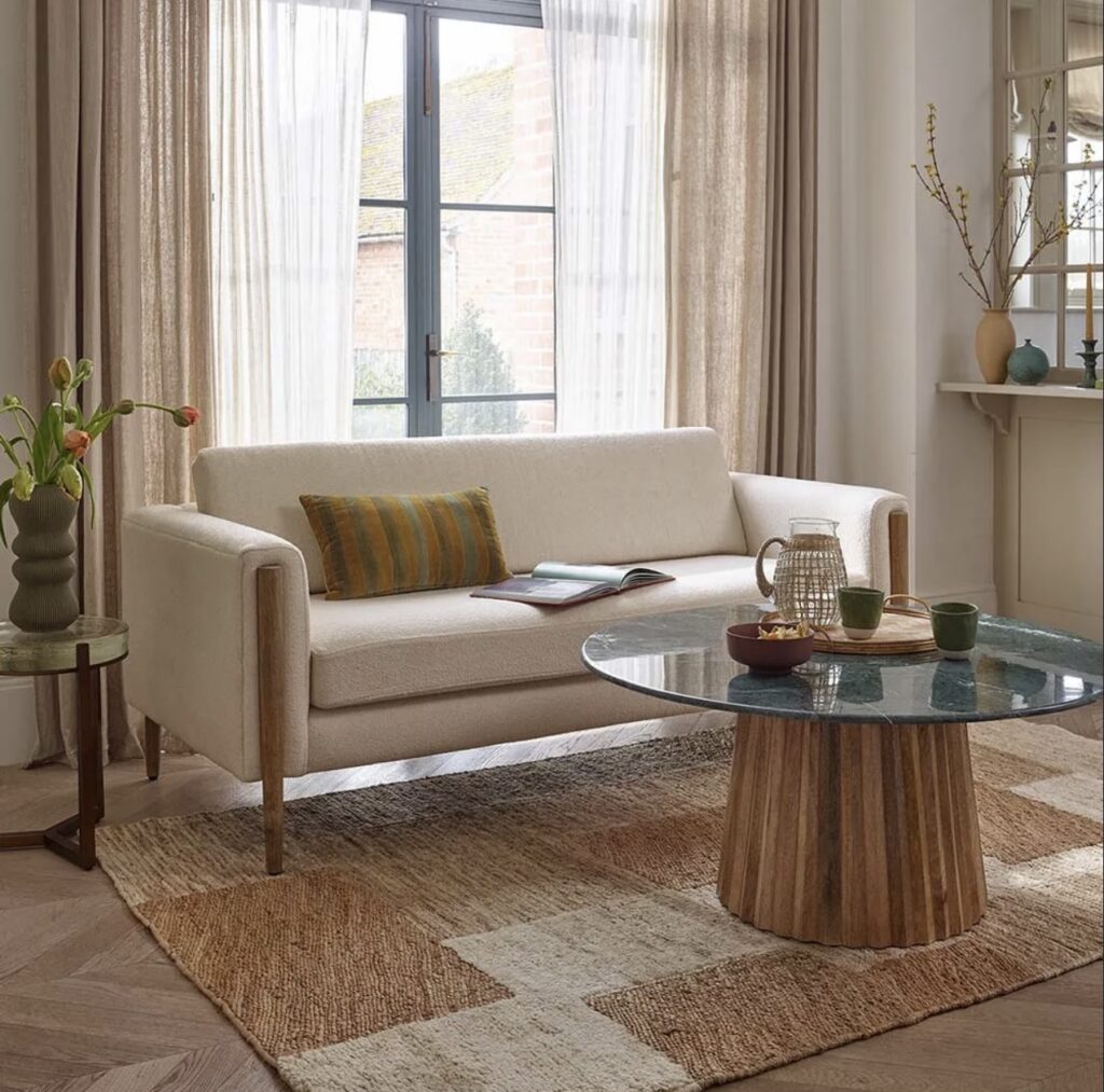 Beige sofa living room with green marble coffee table and jute rug