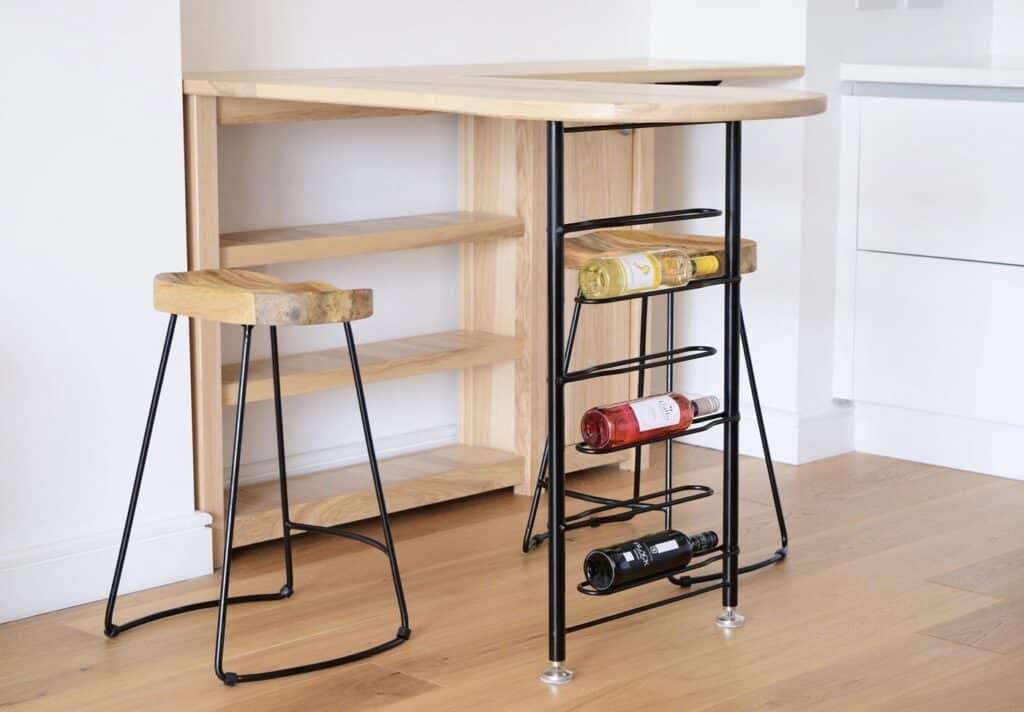 Bespoke japandi kitchen breakfast bar in solid ash hardwood with integrated storage, black metal legs and matching stools by WestgarthWoodworks