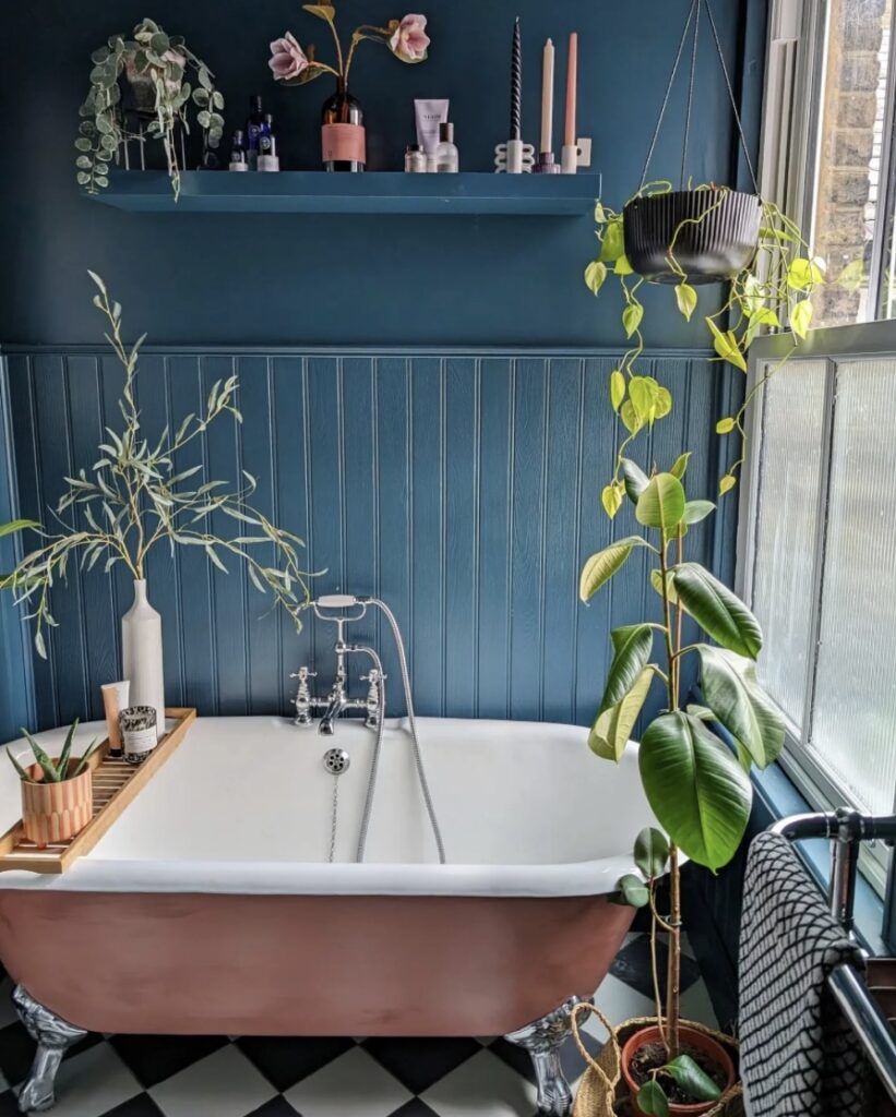 Bathroom wood panelling painted in Hague Blue by Farrow & Ball with copper bathtub