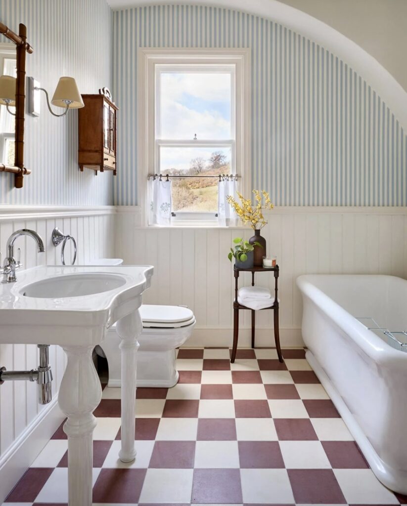 Bathroom wood panelling painted in Wimborne White with blue striped wallpaper by Farrow & Ball