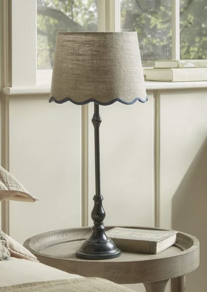 Blue scalloped edge table lamp styled in a cosy blue bedroom – blue bedroom ideas