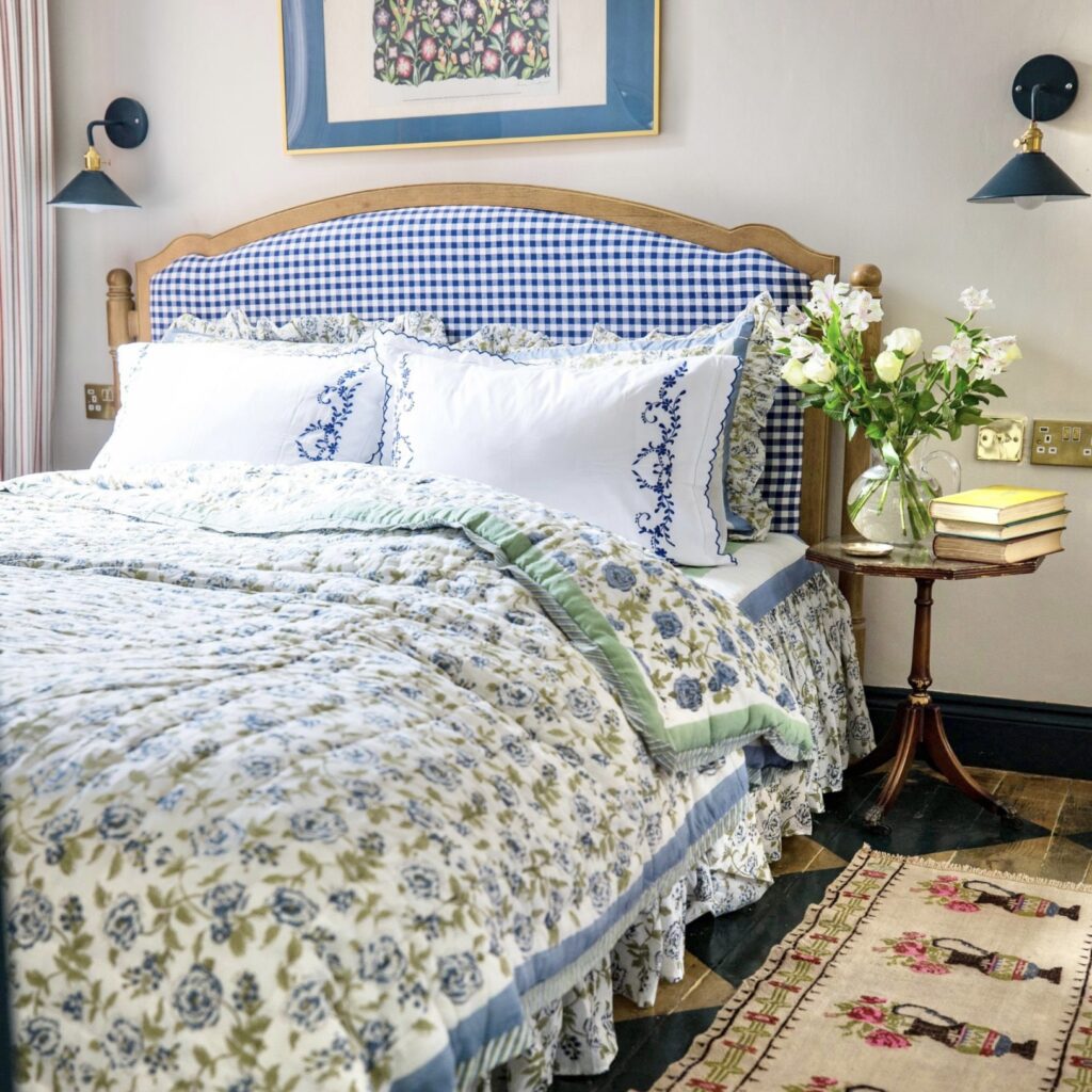 Blue cottage bedroom with gingham headboard and TheCharpoy hand block-printed floral eiderdown.