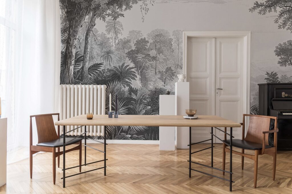 Feature wall ideas: A monochrome jungle-inspired mural transforms a dining space, adding depth and sophistication. The intricate black-and-white design pairs beautifully with natural wood furniture and minimalist decor for a refined, artistic ambiance.