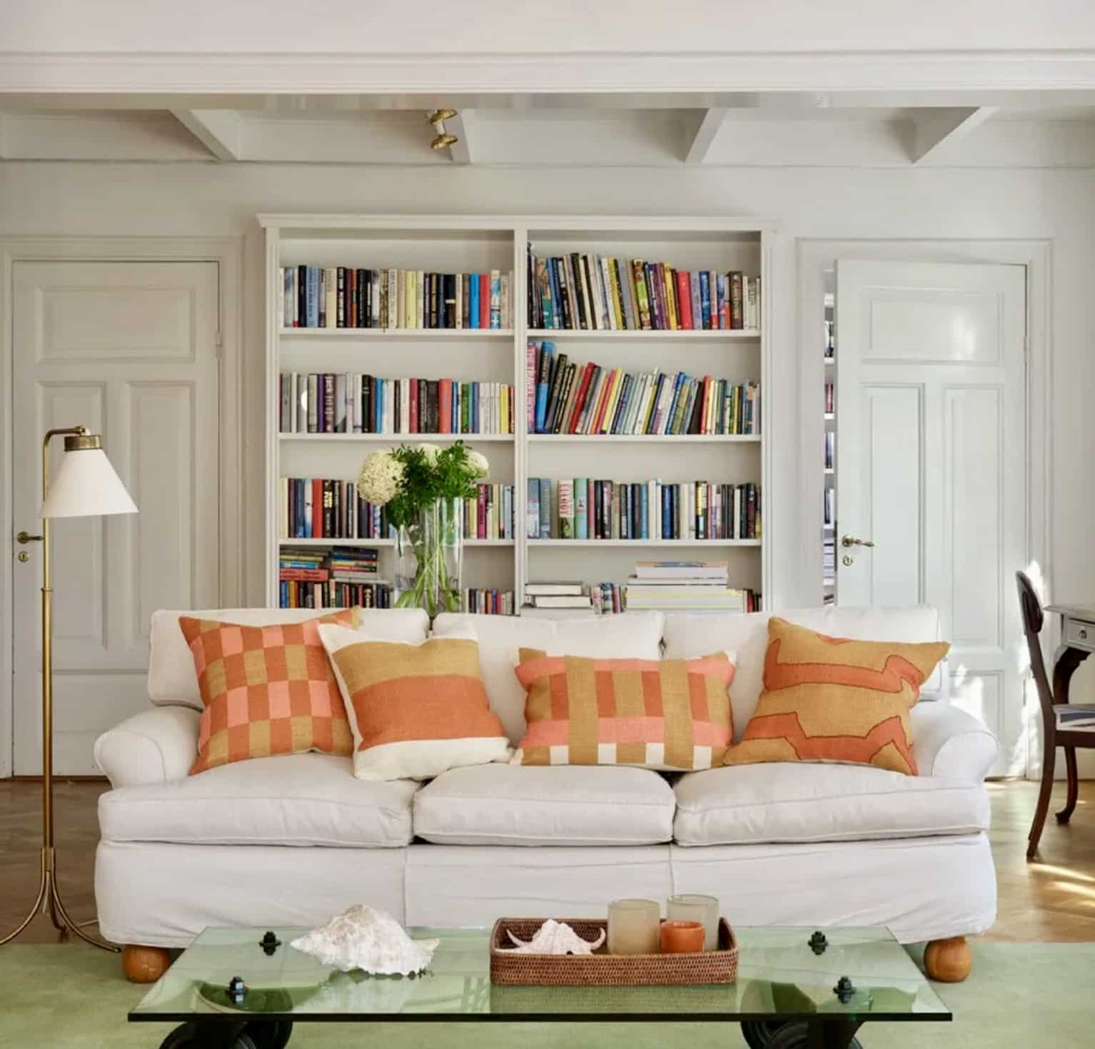 Orange cushions styled on a neutral sofa