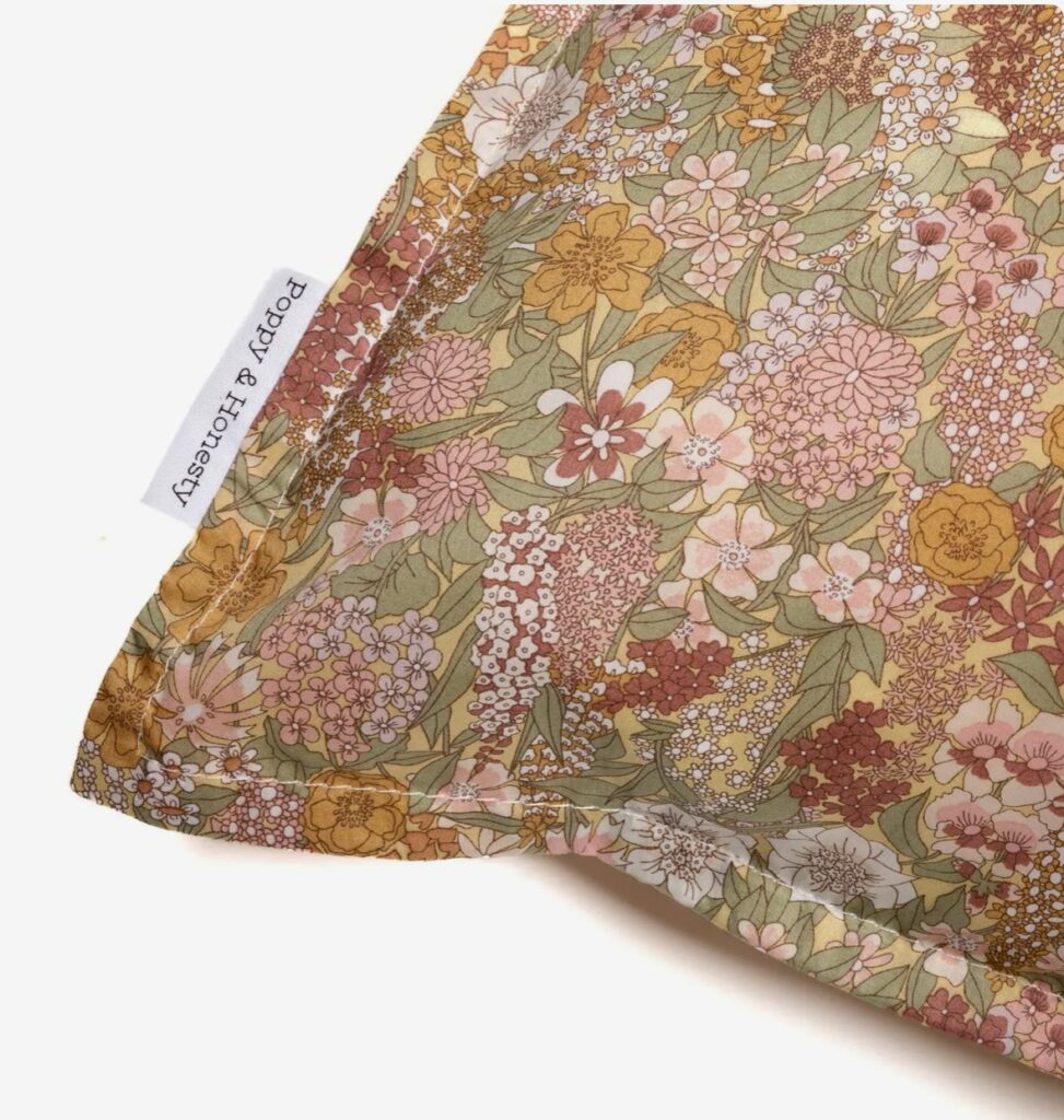 Liberty print pillowcase in Ciara Soft Green – a floral accent for a burnt orange bedroom, perfect for adding elegant contrast to burnt orange home accessories.