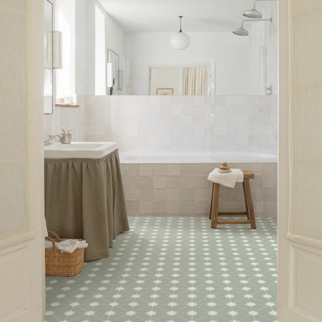 Small bathroom with Laura Green patterned vinyl flooring, white tiles and a fabric sink skirt