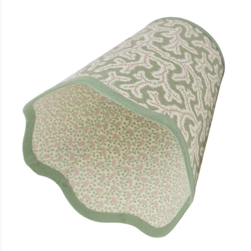Green patterned scalloped lampshade with contrast trim, photographed on a white background.
