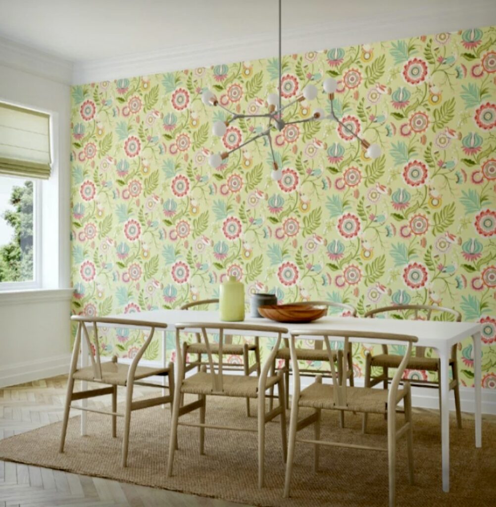 Fresh green floral wallpaper with coral and turquoise blooms in a cheerful dining room.