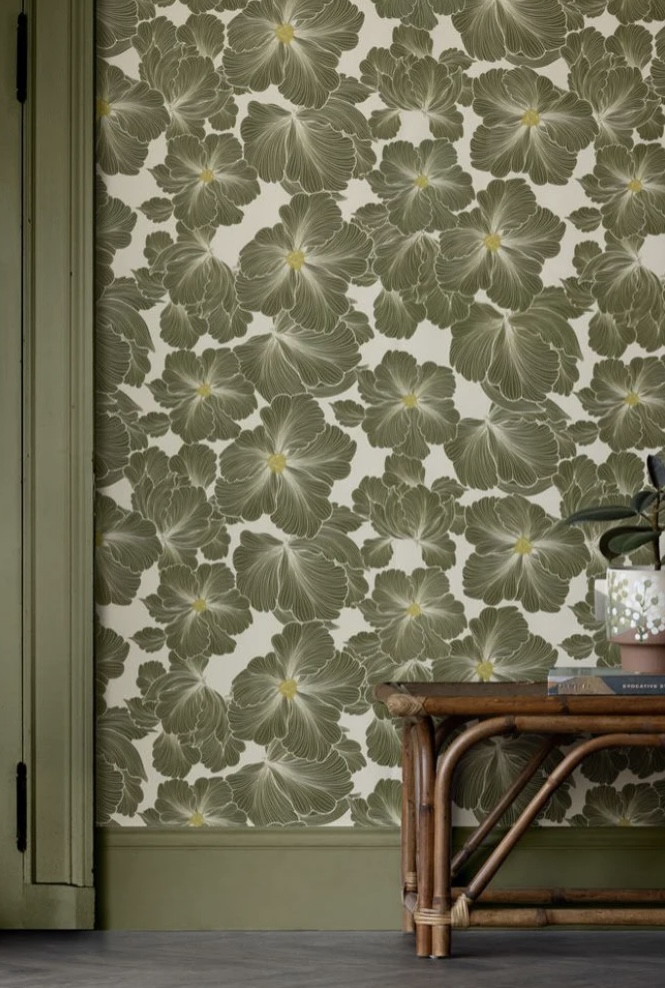 Bold green floral wallpaper with oversized botanical blooms and sage green trim.