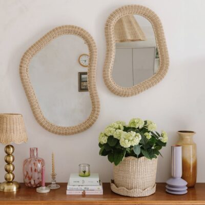 Artisan rattan mirrors and handmade home accessories on wooden console table