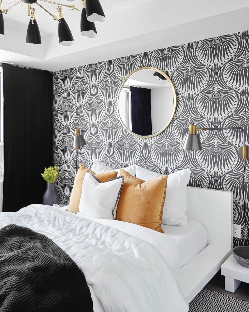 Budget bedroom ideas: bold Farrow & Ball Lotus Wallpaper feature wall with white bedding and amber cushions @t.h.e.style.c.o