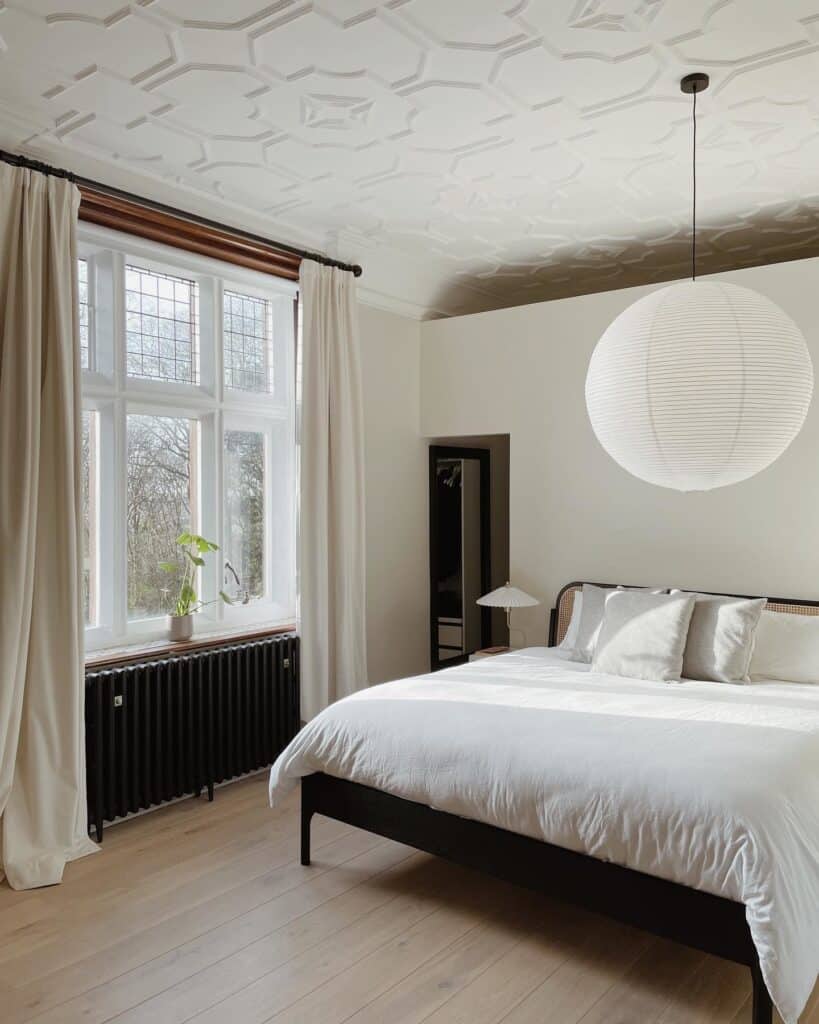 Budget bedroom ideas: minimalist beige bedroom with Farrow & Ball School House White, paper pendant and linen curtains @thehall_home