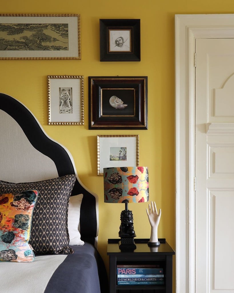 Budget bedroom ideas: gallery wall with mismatched frames on Farrow and Ball Babouche yellow walls @susibellamy