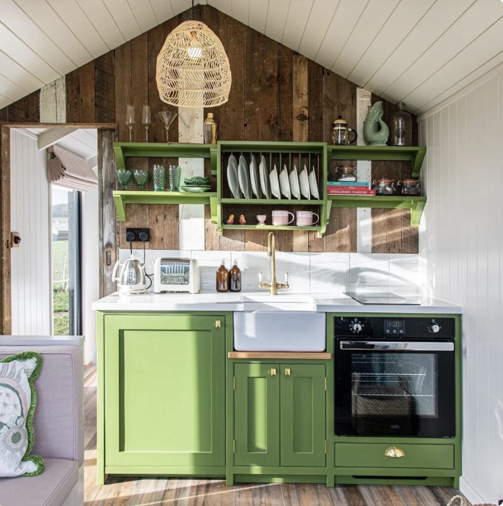 Small kitchen ideas with Farrow & Ball Sap Green in a rustic cottage kitchen with wood cladding
