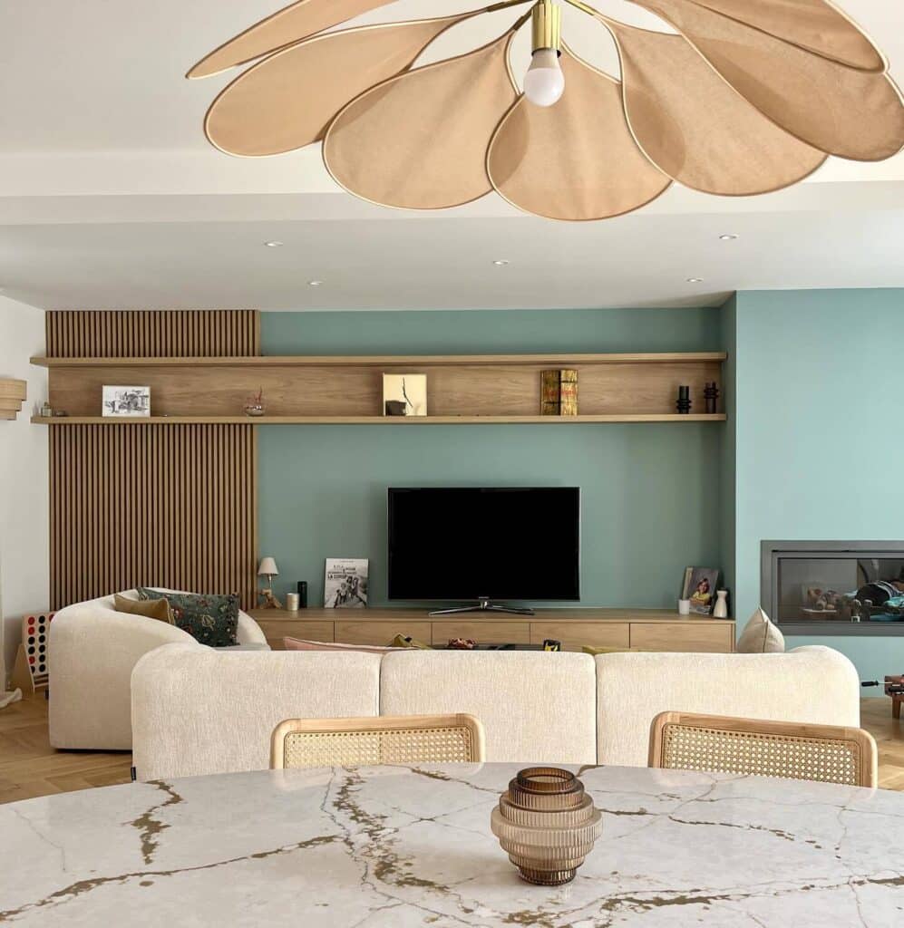 Farrow & Ball Dix Blue open-plan living room with oak slat panelling, integrated shelving, cream bouclé sofa and large petal ceiling light — @neufoctobre. Image credit: Farrow & Ball.