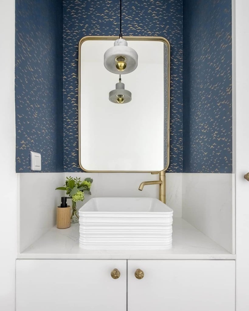 Farrow & Ball Yukutori wallpaper in a coastal cloakroom with brass tap, vessel basin and gold-framed mirror — @s.h.k.architecture. Image credit: Farrow & Ball.