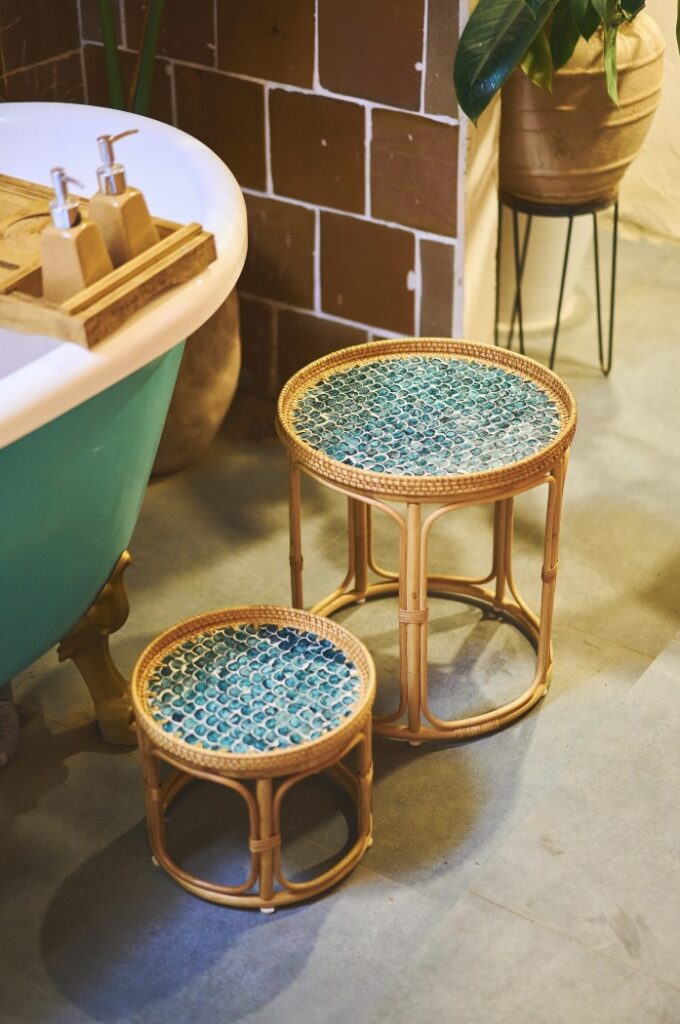 Boho rattan table set with turquoise mosaic top, styled beside a green bath in a coastal home decor bathroom.