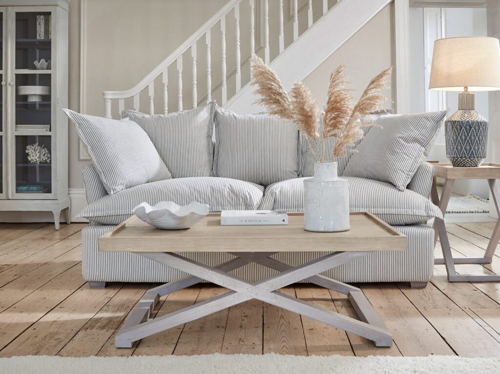 Umea Sofa in a coastal living room – pale wood floors and French blue cushions for a beach house feel