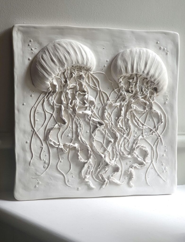 White jellyfish wall sculpture in eco-resin, styled on a windowsill for coastal décor