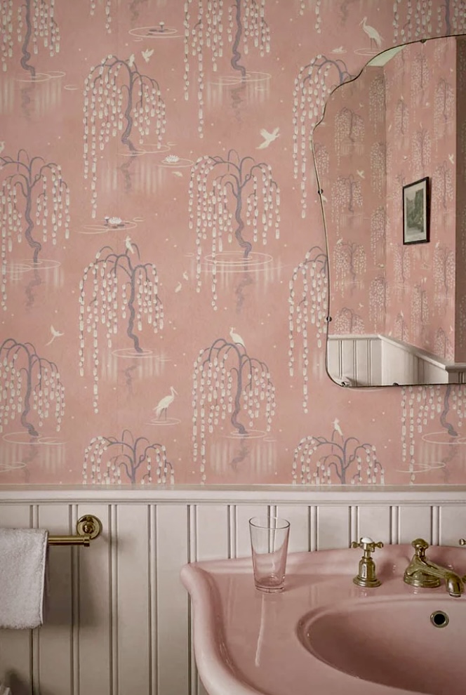 Vintage pink bathroom with patterned wallpaper and pink basin