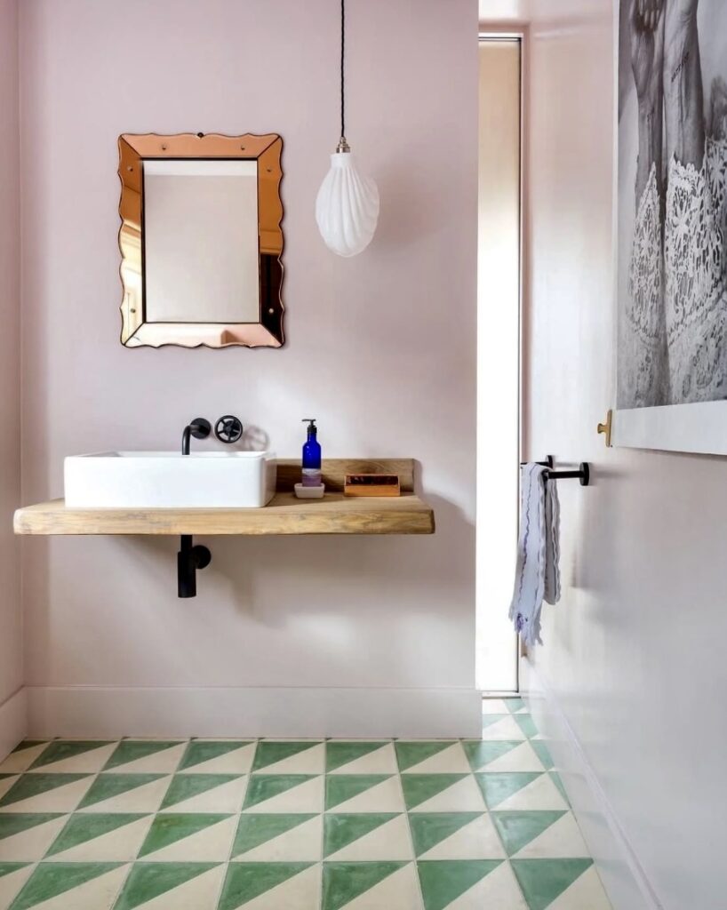 Minimalist pink bathroom with pale pink bathroom paint and green tiled floor