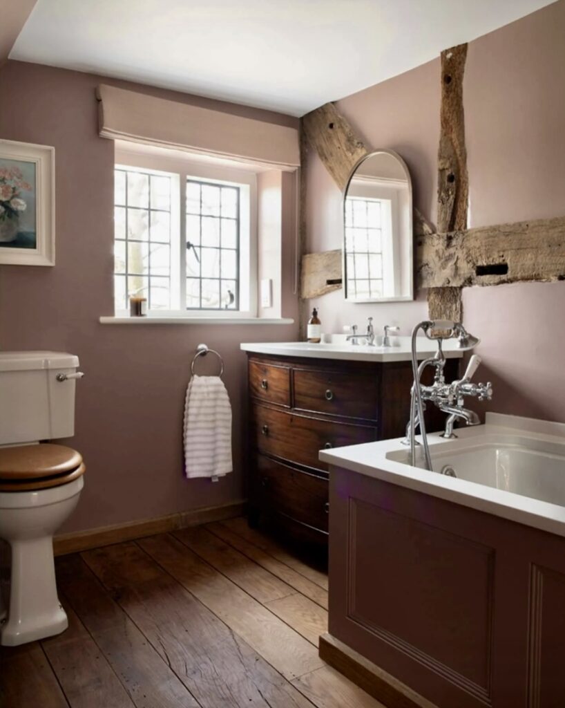 Rustic pink bathroom with exposed beams and dusky pink bathroom paint