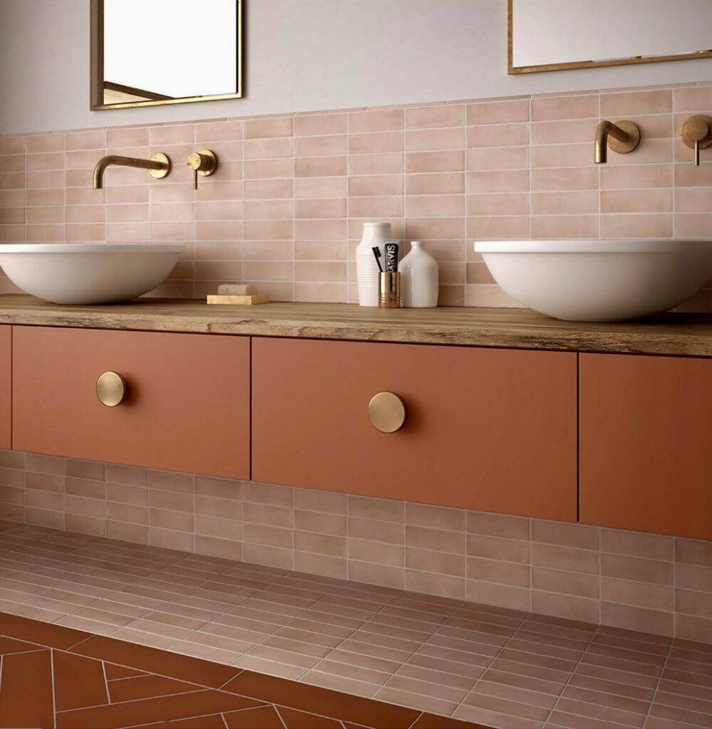 Contemporary pink bathroom with pale pink bathroom tiles and burnt orange vanity