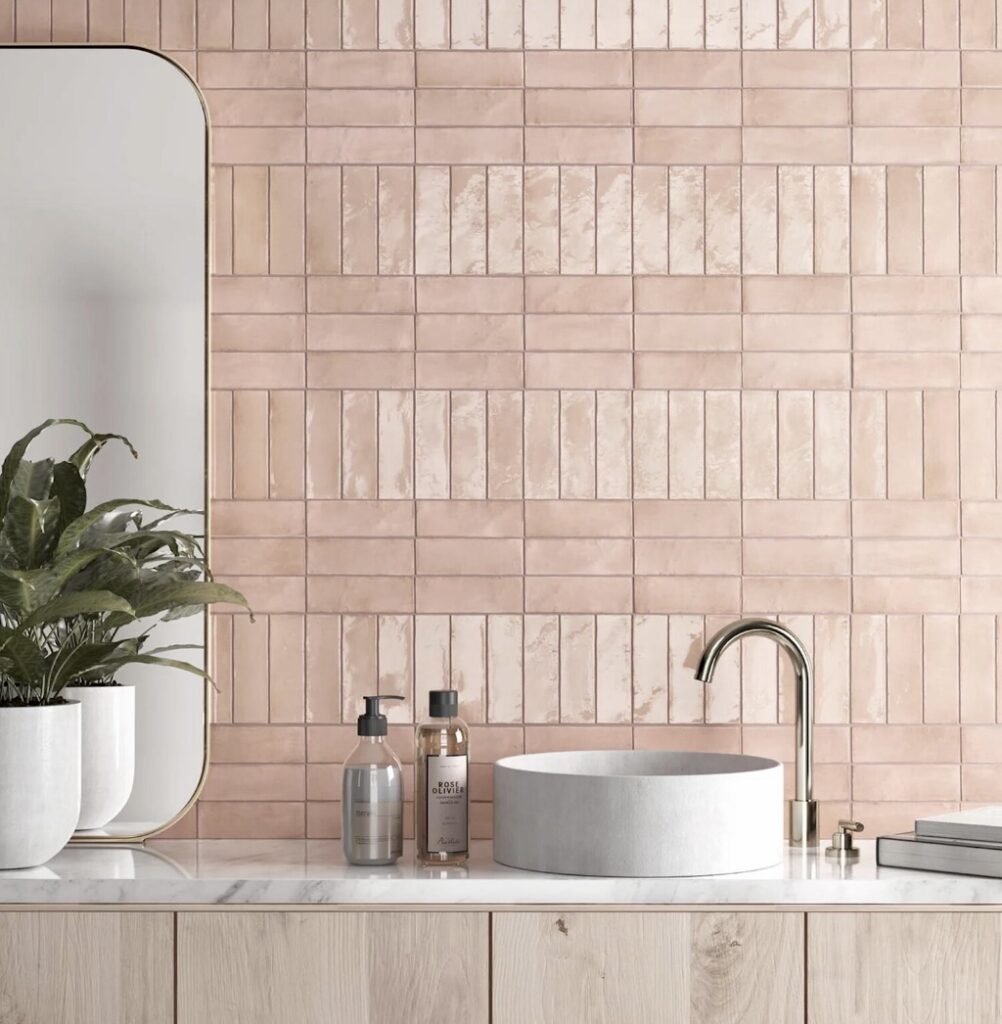 Modern pink bathroom with glossy pink bathroom tiles and round basin