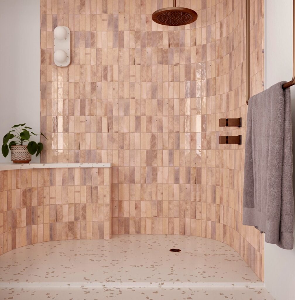 Walk-in shower in a modern pink bathroom with vertical pink bathroom tiles