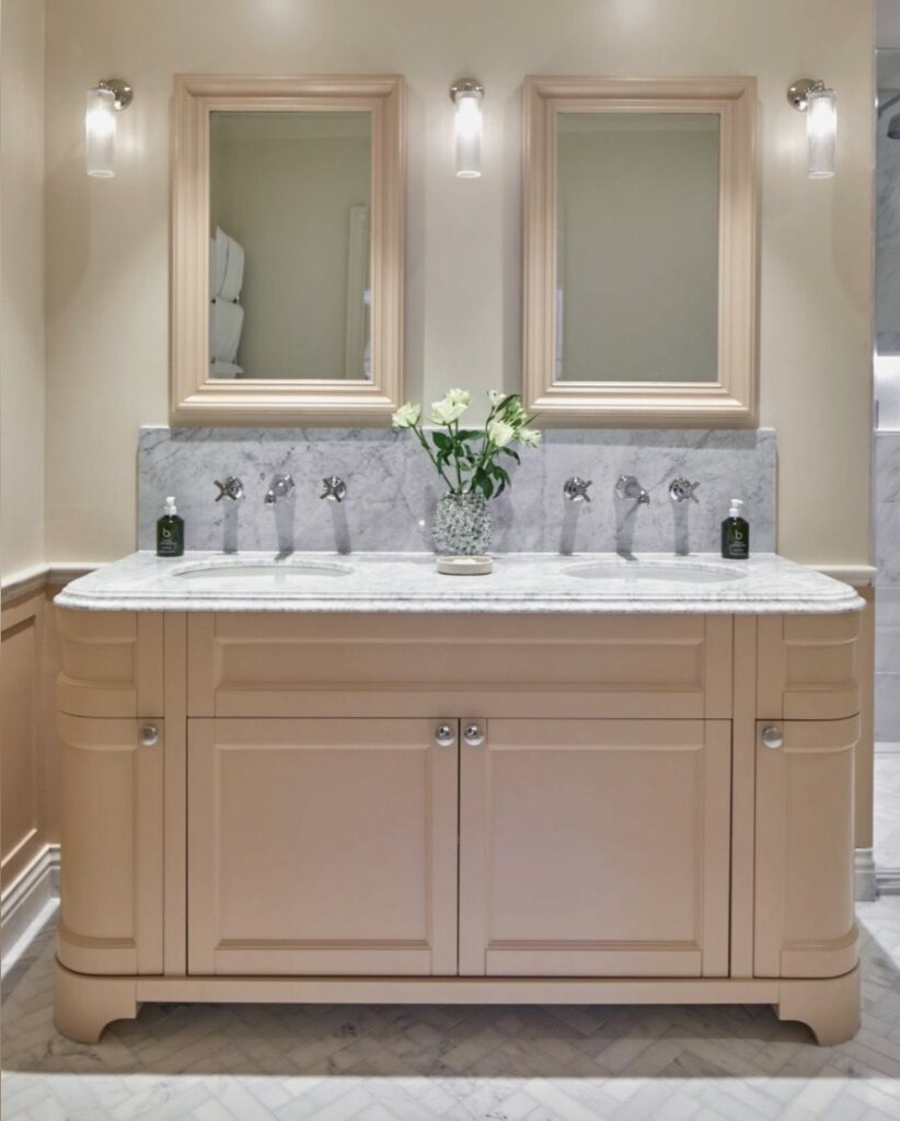 Setting Plaster pink bathroom with a blush vanity, marble splashback, double basin and classic framed mirrors