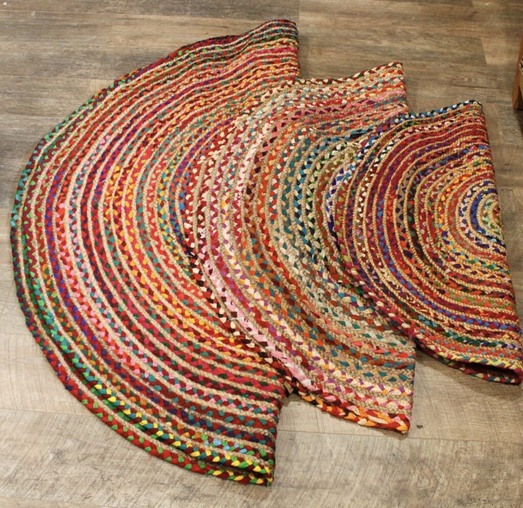 Round handmade rag rug made from recycled denim and sari fabric in multicolour braided stripes