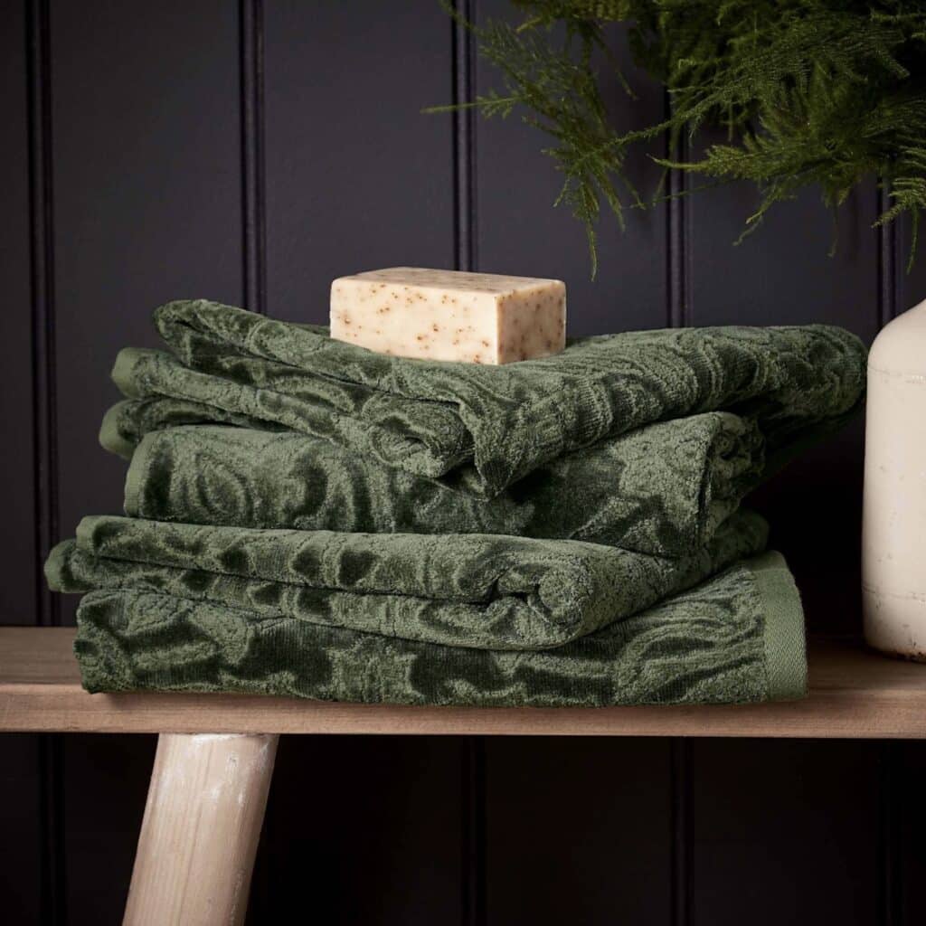 Morris & Co St James towel in sage green showing the abstract floral medallion pattern