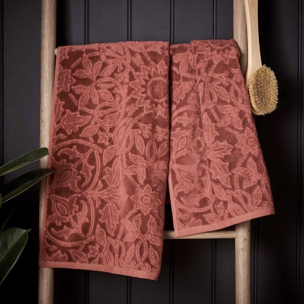 Morris & Co St James towel in red showing the abstract floral medallion pattern