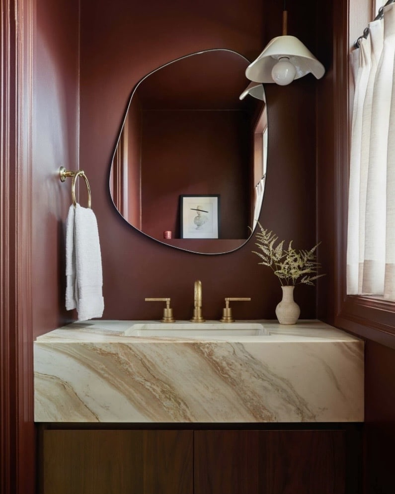 Farrow & Ball Deep Reddish Brown painted bathroom with marble vanity and brass fittings