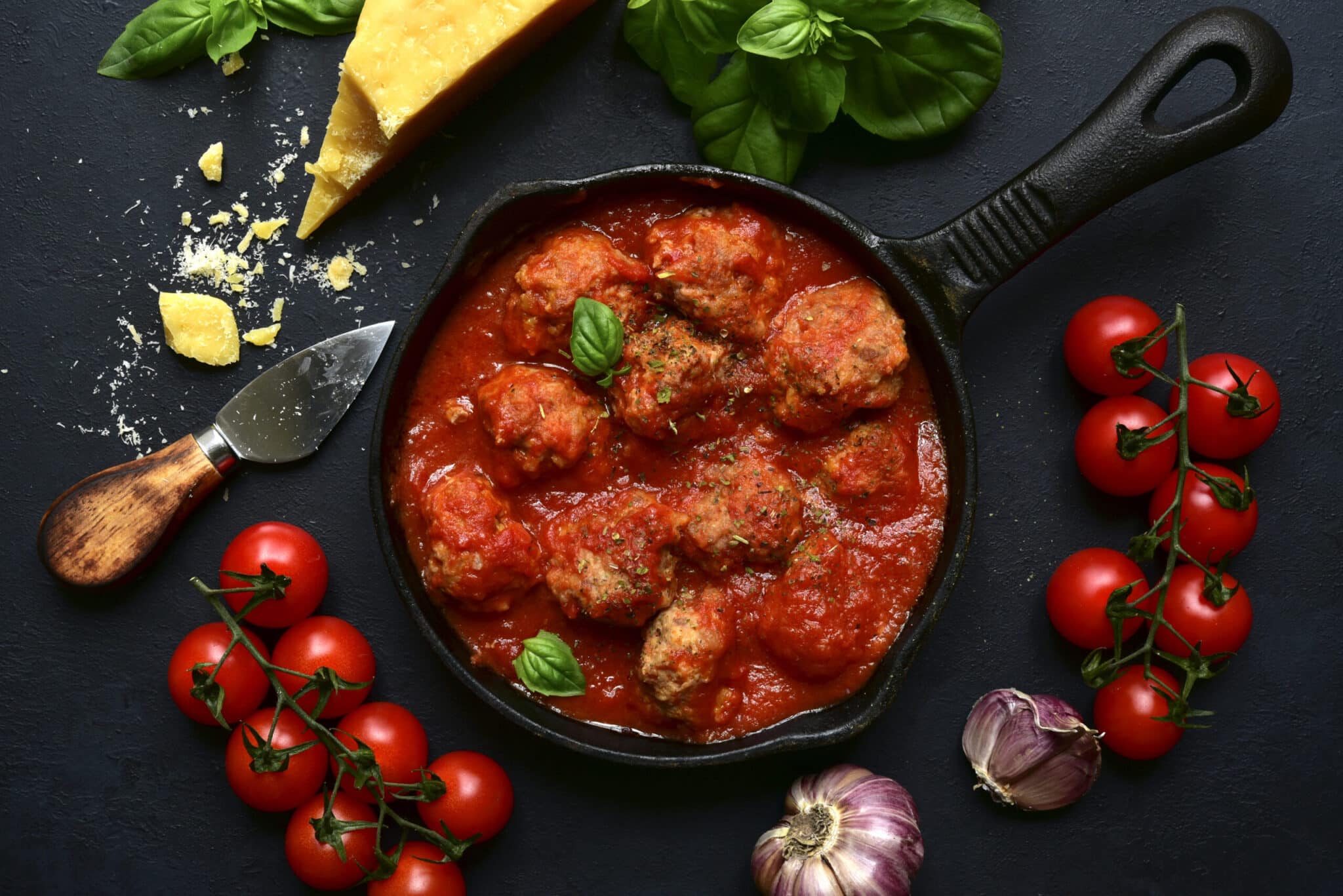 Greek lamb meatballs in tomato sauce topped with feta and herbs