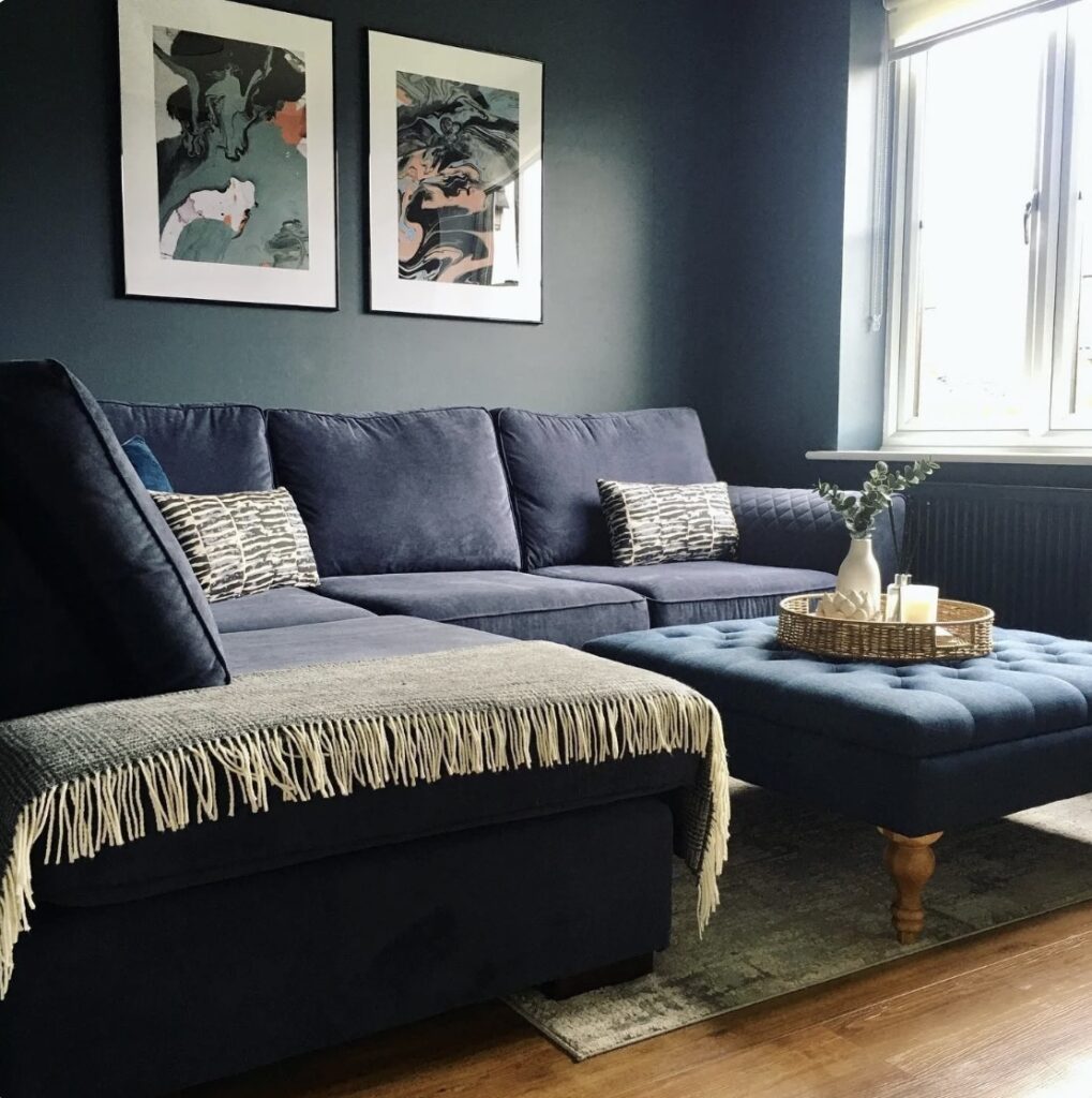Small living room ideas with Hague Blue walls and matching blue sectional sofa for a bold cosy living room design.