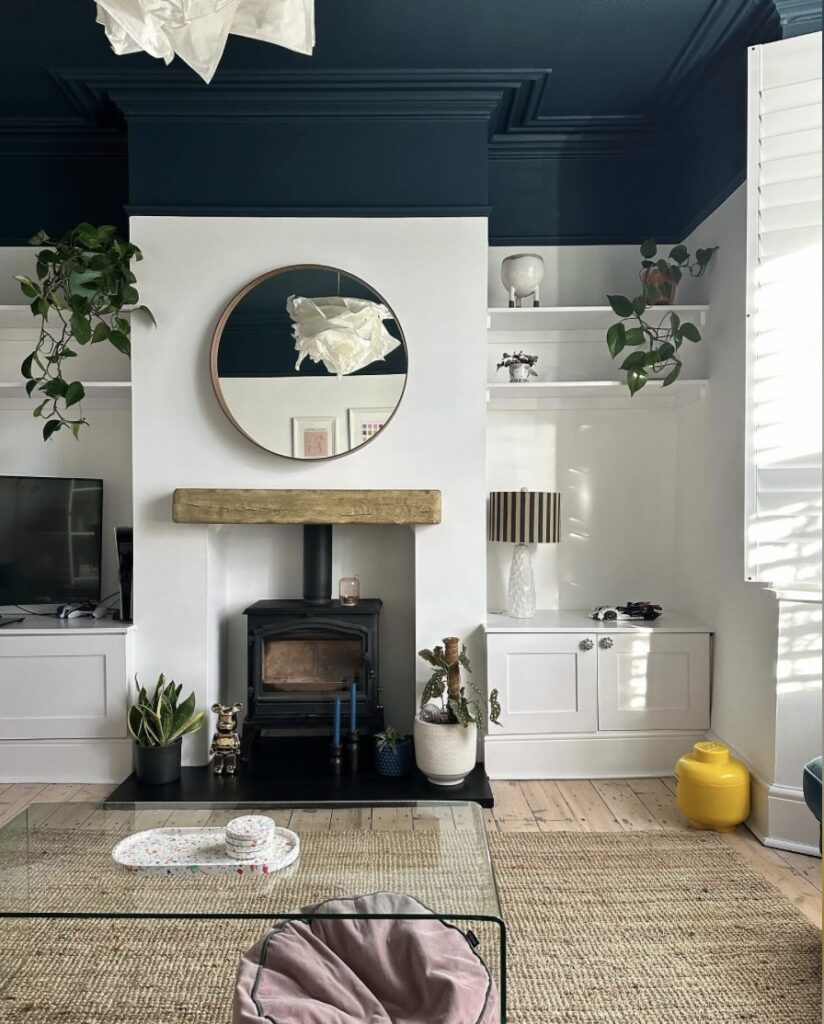 Small living room ideas with Hague Blue ceiling, white walls, and cosy small living room décor featuring a wood burner and jute rug.