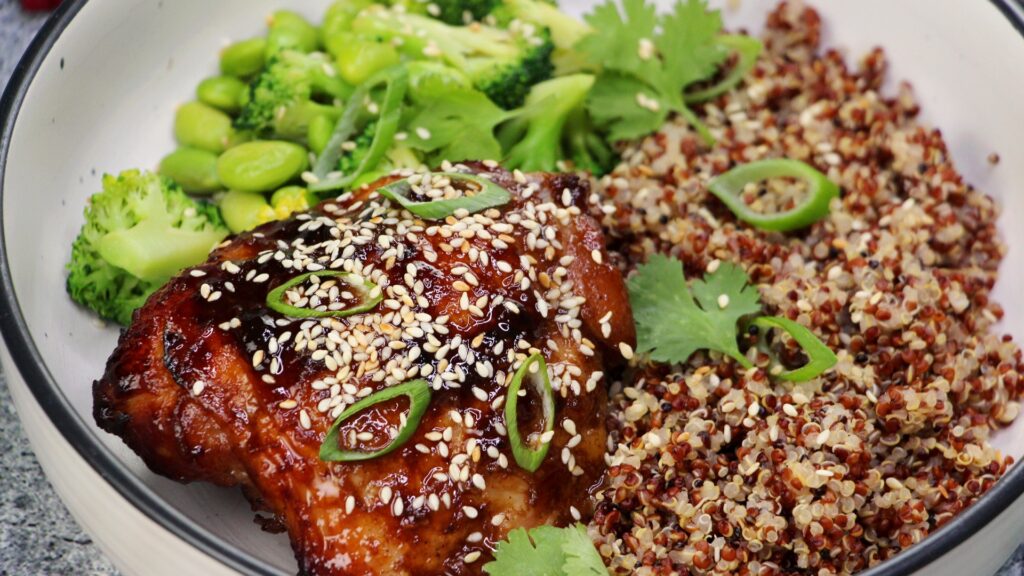 Slow-roasted hoisin chicken served with quinoa, broccoli and edamame — a healthy Asian-inspired dinner bowl.