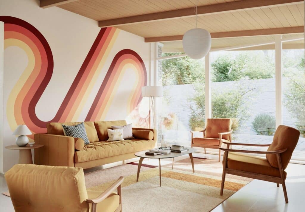 Modern retro interior design with bold 70s rainbow wall mural and statement orange living room furniture
