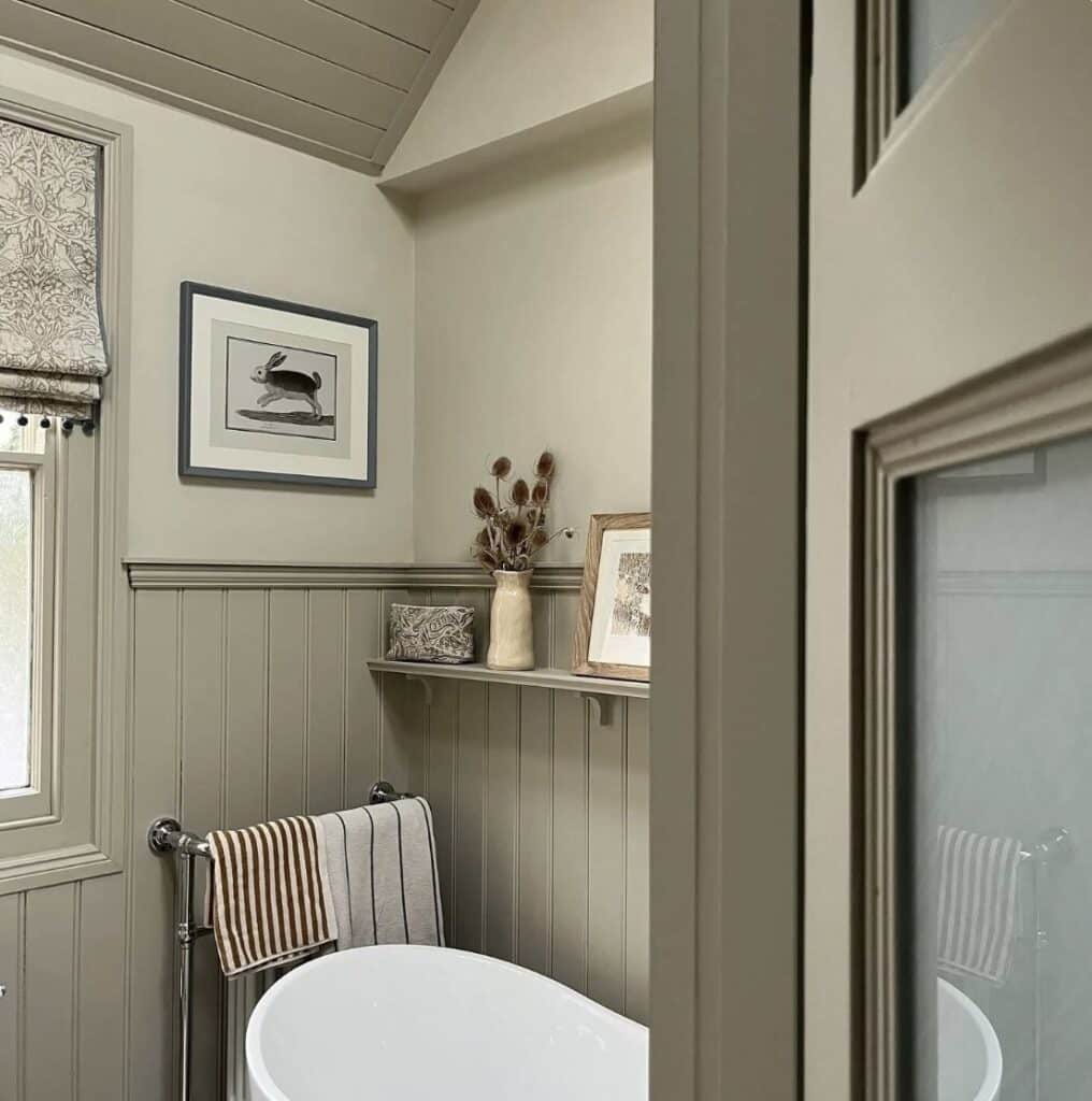 Neutral bathroom in greige tones with freestanding bath, tongue-and-groove panelling, and Farrow & Ball Drop Cloth and Shaded White for a calm, classic look.
