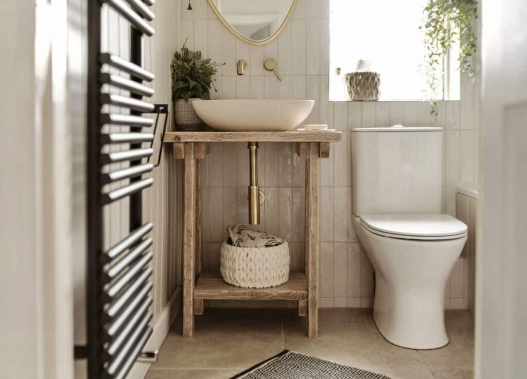 Neutral bathroom ideas with a reclaimed wood washstand, vessel sink and brass plumbing in a compact neutral bathroom (Image: StillandBloom via Etsy)