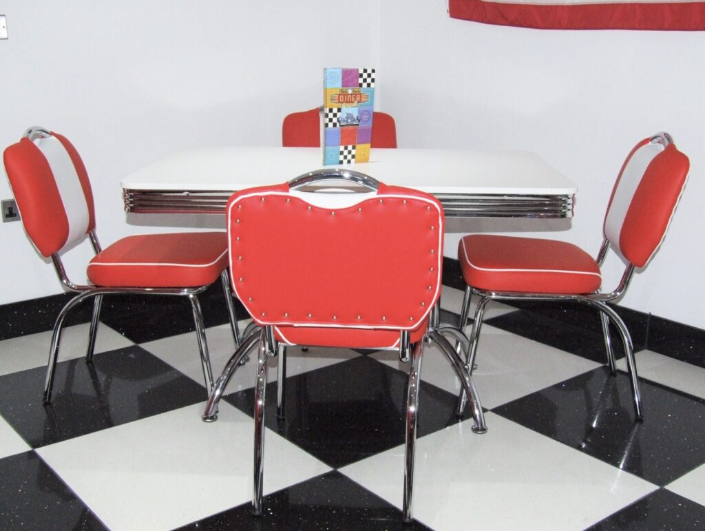 Retro 70s house interior with American diner style furniture and red studded chairs